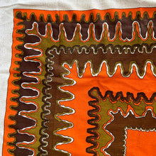 Load image into Gallery viewer, Bring retro flair to your dining room with this eye-catching linen tablecloth that screams 1970s psychedelia. Rendered in cream linen with a bold abstract pattern mixing vibrant orange, warm brown, and muted olive green, it's a statement piece that refuses to blend in. A sturdy woven trim frames the design, adding both visual interest and lasting quality. Perfect for anyone who loves vintage aesthetics and isn't afraid of a little color, this tablecloth transforms an ordinary meal into a groovy experience. 

