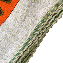Load image into Gallery viewer, Bring retro flair to your dining room with this eye-catching linen tablecloth that screams 1970s psychedelia. Rendered in cream linen with a bold abstract pattern mixing vibrant orange, warm brown, and muted olive green, it's a statement piece that refuses to blend in. A sturdy woven trim frames the design, adding both visual interest and lasting quality. Perfect for anyone who loves vintage aesthetics and isn't afraid of a little color, this tablecloth transforms an ordinary meal into a groovy experience. 
