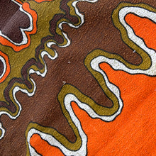 Load image into Gallery viewer, Bring retro flair to your dining room with this eye-catching linen tablecloth that screams 1970s psychedelia. Rendered in cream linen with a bold abstract pattern mixing vibrant orange, warm brown, and muted olive green, it's a statement piece that refuses to blend in. A sturdy woven trim frames the design, adding both visual interest and lasting quality. Perfect for anyone who loves vintage aesthetics and isn't afraid of a little color, this tablecloth transforms an ordinary meal into a groovy experience. 
