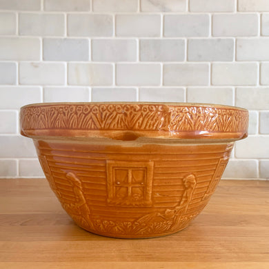Rare find! Vintage orange girl with watering can yellow ware mixing bowl with charming homestead scene, No. 166-10. Crafted by Robinson Ransbottom, USA, 1920s. A well-crafted piece of stoneware offering a nostalgic vibe to your farmhouse or cottage kitchenware and decor!

In excellent condition, no chips/cracks/repairs, age-related crazing. Maker's mark.

Measures 10 3/8 x 5 1/4 inches