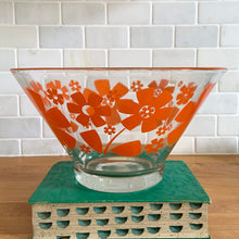 Load image into Gallery viewer, This vintage mid-century era large clear glass chip or salad bowl features graphic orange flowers. Crafted by Anchor Hocking, USA, 1960s. Fill this set with your favourite snacks or salads. The perfect serving piece to brighten up your next party, movie night, game night or get-together. Makes a wonderful housewarming, bridal shower, or birthday gift!

The glass is in excellent overall condition, no chips, minor wear.

Measures 10 3/4 x 5 7/8 inches
