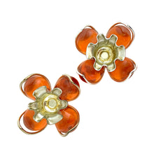 Load image into Gallery viewer, Over head view of pair of vintage mid-century orange lucite candle holders with silver-toned WT Rogers Lustro-Magic wire bases with crimped rims
