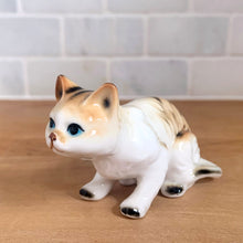 Load image into Gallery viewer, Delightful vintage orange tabby cat porcelain figurine Giftcraft, Japan. Add this sweet figurine to your collection!

In excellent condition, no chips/cracks. Sticker present.

Measures 3 7/8 x 1 1/2 x 2 1/4 inches
