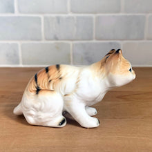 Load image into Gallery viewer, Delightful vintage orange tabby cat porcelain figurine Giftcraft, Japan. Add this sweet figurine to your collection!

In excellent condition, no chips/cracks. Sticker present.

Measures 3 7/8 x 1 1/2 x 2 1/4 inches
