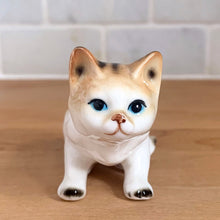 Load image into Gallery viewer, Delightful vintage orange tabby cat porcelain figurine Giftcraft, Japan. Add this sweet figurine to your collection!

In excellent condition, no chips/cracks. Sticker present.

Measures 3 7/8 x 1 1/2 x 2 1/4 inches
