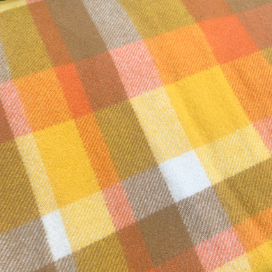 Vintage plaid queen size 100% lambswool blanket, in shades of orange, yellow, ochre and beige, finished with a blanket stitch edge and mothproofed. Crafted in Australia, 1950s. A delightful colour scheme and perfect for getting cozy and warm on a chilly day!

In excellent vintage condition, no stains or tears. With original label.

Measures 84 x 98 inches