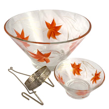 Load image into Gallery viewer, All three components of the vintage Anchor Hocking Enchantware chip and dip set separated — large chip bowl, small dip bowl, and ornate silver-tone metal bracket with filigree ring detail, orange maple leaf pattern, 1950s
