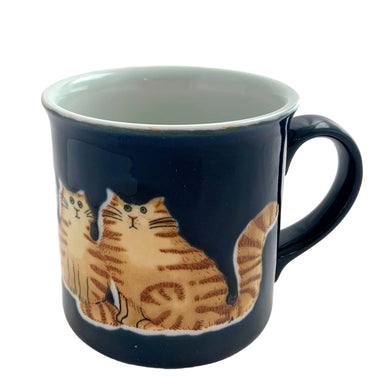 Vintage cobalt blue ceramic mug featuring a sweet orange tabby cat family. Crafted by Otagiri, Japan, 1970s. A cute mug to add to your collection.

In excellent condition, no chips or cracks.

Measures 4 3/4 x 3 1/2 x 3 5/8 inches

Capacity 10 ounces