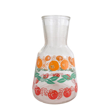 Adorable vintage clear open carafe featuring a design of oranges, red tomatoes and green leaves, plus a ribbed neck. Crafted by Hazel-Atlas Glass, USA, circa 1960s.  In excellent condition, free from chips/wear.  Measures 7 3/4 inches tall  Capacity 32 ounces   