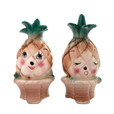 Vintage mid-century era anthropomorphic pineapple people ceramic salt and pepper shakers with rubber stoppers. Japan, 1950s. Add these adorable kitschy shakers to your collection!

In as found vintage condition, flea bite on one shaker, chip on the other, no cracks/repairs. Marked Japan.

Measures 2 x 1 3/4 x 4 inches