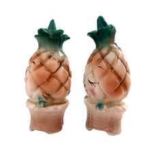 Load image into Gallery viewer, Vintage mid-century era anthropomorphic pineapple people ceramic salt and pepper shakers with rubber stoppers. Japan, 1950s. Add these adorable kitschy shakers to your collection!

In as found vintage condition, flea bite on one shaker, chip on the other, no cracks/repairs. Marked Japan.

Measures 2 x 1 3/4 x 4 inches
