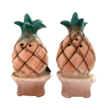 Load image into Gallery viewer, Vintage mid-century era anthropomorphic pineapple people ceramic salt and pepper shakers with rubber stoppers. Japan, 1950s. Add these adorable kitschy shakers to your collection!

In as found vintage condition, flea bite on one shaker, chip on the other, no cracks/repairs. Marked Japan.

Measures 2 x 1 3/4 x 4 inches
