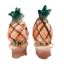 Load image into Gallery viewer, Vintage mid-century era anthropomorphic pineapple people ceramic salt and pepper shakers with rubber stoppers. Japan, 1950s. Add these adorable kitschy shakers to your collection!

In as found vintage condition, flea bite on one shaker, chip on the other, no cracks/repairs. Marked Japan.

Measures 2 x 1 3/4 x 4 inches
