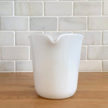 Load image into Gallery viewer, Vintage PYREX white opal milk glass handled creamer. Crafted by Corning, USA. The charming sidekick to your morning coffee or tea!

In excellent condition, no chips/cracks.

Measures 3 3/8 x 3 5/8 inches
