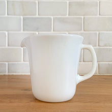 Load image into Gallery viewer, Vintage PYREX white opal milk glass handled creamer. Crafted by Corning, USA. The charming sidekick to your morning coffee or tea!

In excellent condition, no chips/cracks.

Measures 3 3/8 x 3 5/8 inches
