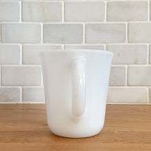 Load image into Gallery viewer, Vintage PYREX white opal milk glass handled creamer. Crafted by Corning, USA. The charming sidekick to your morning coffee or tea!

In excellent condition, no chips/cracks.

Measures 3 3/8 x 3 5/8 inches
