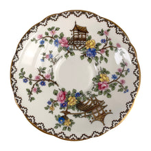 Load image into Gallery viewer, Vintage Pagoda Chinoiserie motif fine bone china teacup and saucer featuring hand painted brown pagoda and flowers in shades of pink, blue, yellow and green with gold gilt trim and scalloped edges. Crafted by Aynsley, England, 1920s. A lovely way to enjoy a cuppa tea!

In excellent condition, no chips, cracks or repairs. Maker&#39;s mark on the bottom.

Measures 3 1/2 x 2 1/4 inches | Saucer measures 5 1/2 inches
