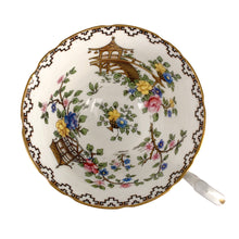 Load image into Gallery viewer, Vintage Pagoda Chinoiserie motif fine bone china teacup and saucer featuring hand painted brown pagoda and flowers in shades of pink, blue, yellow and green with gold gilt trim and scalloped edges. Crafted by Aynsley, England, 1920s. A lovely way to enjoy a cuppa tea!

In excellent condition, no chips, cracks or repairs. Maker&#39;s mark on the bottom.

Measures 3 1/2 x 2 1/4 inches | Saucer measures 5 1/2 inches
