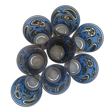 Load image into Gallery viewer, Vintage mid-century era set of eight royal blue and 22kt gold Paisley glass cocktail tumblers in brass caddy with teak handle. Crafted by Culver, USA, 1970s. Highly sought after by collectors, these gorgeous tumblers will make an excellent addition to your barware collection!

In great vintage condition, no chips, minor wear.

Tumblers measure inches 2 3/4 x 5 1/2 inches

Caddy measures 12 ounces
