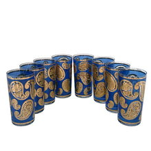 Load image into Gallery viewer, Vintage mid-century era set of eight royal blue and 22kt gold Paisley glass cocktail tumblers in brass caddy with teak handle. Crafted by Culver, USA, 1970s. Highly sought after by collectors, these gorgeous tumblers will make an excellent addition to your barware collection!

In great vintage condition, no chips, minor wear.

Tumblers measure inches 2 3/4 x 5 1/2 inches

Caddy measures 12 ounces
