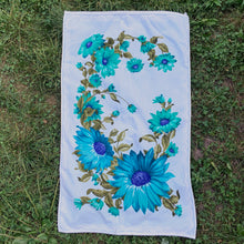 Load image into Gallery viewer, A vintage pale blue ultra soft cotton terry cloth bath towels featuring a striking spray of flowers in shades of turquoise, blue and green with an inset scalloped border pattern. Crafted by Besana, Italy. This gorgeous towel is sure to amplify your bath!  In excellent condition, free form tears/stains. Possibly new old stock.  Measures 47 inches x 27 1/2 inches
