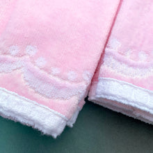 Load image into Gallery viewer, A vintage pale salmon pink ultra soft cotton terry cloth bath towels featuring a striking spray of flowers in shades of salmon, charcoal and green with an inset scalloped border pattern. Crafted by Besana, Italy. This gorgeous towel is sure to amplify your bath!  In excellent condition, free form tears/stains. Possibly new old stock.  Measures 47 inches x 27 1/2 inches
