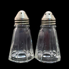 Load image into Gallery viewer, These antique vintage depression era paneled clear glass salt and pepper shakers with metal lids were produced by Hazel-Atlas Glass, USA, circa 1920s. This timeless kitchen accessory adds a unique accent to your kitchen and table decor! In used vintage condition, minor roughness on a couple of the panels, see photos. Measures 1 1/2 x 2 7/8 inches
