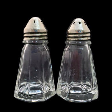 These antique vintage depression era paneled clear glass salt and pepper shakers with metal lids were produced by Hazel-Atlas Glass, USA, circa 1920s. This timeless kitchen accessory adds a unique accent to your kitchen and table decor! In used vintage condition, minor roughness on a couple of the panels, see photos. Measures 1 1/2 x 2 7/8 inches