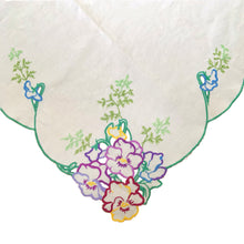 Load image into Gallery viewer, Vintage ecru linen tablecloth featuring hand embroidered pansies in purple, raspberry, blue, yellow and finished with a scalloped edge in green. It&#39;s a beauty! In great vintage condition, free from stains/tears. Measures 40 x 40 inches
