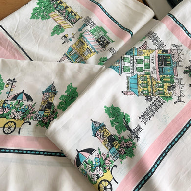 Expertly crafted from high-quality white cotton, this timeless classic mid-century era rectangular tablecloth features a charming Parisian motif showcasing iconic landmarks, architecture, and cafés in shades of pink, black, blue, yellow, and green. Elevate your dining experience and take a stroll through Paris with this charming tablecloth.

In good vintage condition, no stains minor edge fray in one spot.

Measures 46 x 64 inches