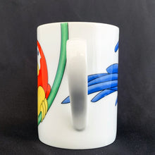 Load image into Gallery viewer, This bright and energetic &quot;Parrot-in-Ring&quot; white ceramic mug is so much fun. This cheeky grinned parrot is brightly coloured in orange, yellow, green and blue. Produced by Fitz &amp; Floyd, Japan, 1979.  In excellent vintage condition, free from chips/cracks. Marked on the bottom &quot;Parrot-in-Ring, Fitz &amp; Floyd Inc., ©MCMLXXIX, FF, 64&quot;  Measures 2 3/4 x 3 3/4 inches  Capacity 11 ounces
