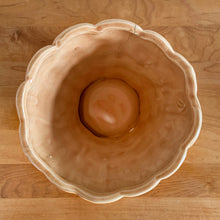 Load image into Gallery viewer, Vintage gloss peach pebble planter pot with attached saucer. Crafted by McCoy Pottery, 1950s. This rare planter is must for any McCoy art pottery collector!

In as found vintage condition, no chips, interior tight hairline crack, crazing. Marked 303 and 5 on the bottom.

Measures 5 1/2 x 5 1/4 inches
