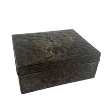 Load image into Gallery viewer, This gorgeous handmade vintage metal lidded trinket box features an embossed proud peacock atop the hinged lid with florals on the side set against a graphic repeating scalloped pattern. The interior is lined with navy blue velvet and the exteriors heavy patina adds to the beauty of the well-crafted box. A stunning piece that will add a bit of mysterious Bohemian whimsy  to your decor!  In good vintage condition. South East Asian origin.  Measures 3 5/8 x 3 x 1 1/2 inches   
