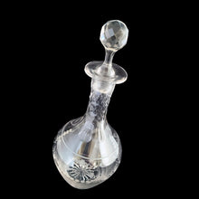 Load image into Gallery viewer, Add a touch of elegance to your tablescape with this antique vintage cut crystal decanter featuring strings of pearls and vines cut around the body with faceted neck and stopper. Bring a little sparkle to your home with this one-of-a-kind piece!

In good vintage condition, no chips, but there is a tiny flea nick on the stopper end.

Measures 3 3/8 x 9 inches
