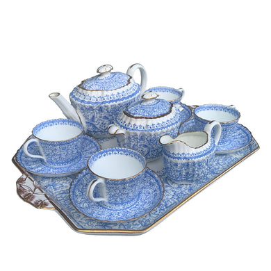 Stunning antique bone china tea set features the Persian pattern in blue florals on white bone china with gold gilt details. Crafted by William Alsager Adderley, WAA & Co., and manufactured at the Daisy Bank Pottery, Longton, Stoke-on-Trent, England, between 1886 - 1905. A stunning groups of bone and opaline china.
Open stock, teapot, covered sugar, creamer set, tray and four cup and saucer sets (two sets are imperfect)