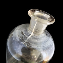 Load image into Gallery viewer, Late 19th century antique hand blown glass pharmacist&#39;s apothecary jar with stopper. The hand painted label reads LIN.CAMPH.CO. and the label glass has a gold border. Pontil scar on the bottom. These bottles were crafted by skilled glassblowers and used to house chemical compounds in pharmacies...a cool piece of history. In as found condition, there appears to be a crack at the neck and the glass over the label has damage, see photos. Measures 3 3/8 x 9 5/8 inches
