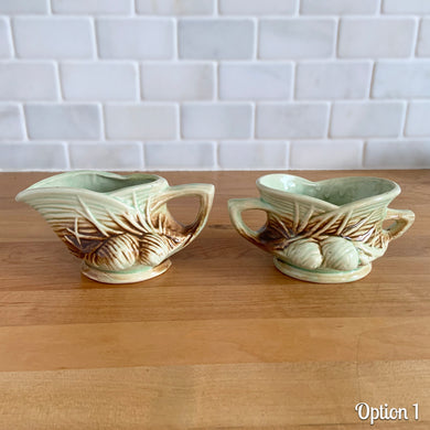 Striking vintage gloss glazed Pinecone sugar and creamer in shades of green and brown. Crafted by McCoy Pottery, 1946. Complete your tea set with this rare set, a must for any McCoy art pottery collector. Makes a nice complement to your Christmas, cottage or lodge decor!

Option 1: Creamer measures 5 5/8 x 3 1/4 x 2 7/8 inches. Sugar measures 5 1/2 x 3 3/8 x 2 3/4 inches. In excellent condition, no chips/cracks/repairs, age-related crazing. Maker's mark.