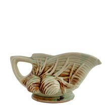 Load image into Gallery viewer, Striking vintage gloss glazed Pinecone creamer in shades of green and brown. Crafted by McCoy Pottery, 1946. Complete your tea set with this rare creamer, a must for any McCoy art pottery collector. Makes a nice complement to your Christmas, cottage or lodge decor!

In good vintage condition, manufacturer&#39;s defect on rim, no cracks/repairs, crazing commensurate with age, Maker&#39;s mark on the bottom.

Measures 5 3/4 x 3 1/8 x 2 7/8 inches
