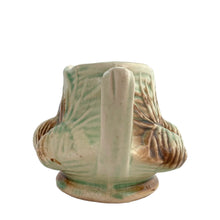 Load image into Gallery viewer, Striking vintage gloss glazed Pinecone creamer in shades of green and brown. Crafted by McCoy Pottery, 1946. Complete your tea set with this rare creamer, a must for any McCoy art pottery collector. Makes a nice complement to your Christmas, cottage or lodge decor!

In good vintage condition, manufacturer&#39;s defect on rim, no cracks/repairs, crazing commensurate with age, Maker&#39;s mark on the bottom.

Measures 5 3/4 x 3 1/8 x 2 7/8 inches
