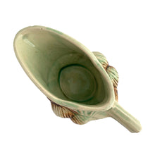 Load image into Gallery viewer, Striking vintage gloss glazed Pinecone creamer in shades of green and brown. Crafted by McCoy Pottery, 1946. Complete your tea set with this rare creamer, a must for any McCoy art pottery collector. Makes a nice complement to your Christmas, cottage or lodge decor!

In good vintage condition, manufacturer&#39;s defect on rim, no cracks/repairs, crazing commensurate with age, Maker&#39;s mark on the bottom.

Measures 5 3/4 x 3 1/8 x 2 7/8 inches
