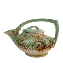 Load image into Gallery viewer, Striking vintage matted glazed Pinecone teapot in shades of green and brown. Crafted by McCoy Pottery, 1946. This rare teapot is must for any McCoy art pottery collector and a nice complement to your Christmas, cottage or lodge decor!

In good vintage condition, chip at spout, no crazing/cracks/repairs, Maker&#39;s mark on the bottom.

Measures 9 3/4 x 6 1/4 x 6 1/4 inches
