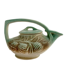Load image into Gallery viewer, Striking vintage matted glazed Pinecone teapot in shades of green and brown. Crafted by McCoy Pottery, 1946. This rare teapot is must for any McCoy art pottery collector and a nice complement to your Christmas, cottage or lodge decor!

In good vintage condition, chip at spout, no crazing/cracks/repairs, Maker&#39;s mark on the bottom.

Measures 9 3/4 x 6 1/4 x 6 1/4 inches
