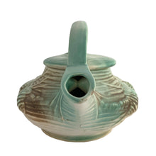 Load image into Gallery viewer, Striking vintage matted glazed Pinecone teapot in shades of green and brown. Crafted by McCoy Pottery, 1946. This rare teapot is must for any McCoy art pottery collector and a nice complement to your Christmas, cottage or lodge decor!

In good vintage condition, chip at spout, no crazing/cracks/repairs, Maker&#39;s mark on the bottom.

Measures 9 3/4 x 6 1/4 x 6 1/4 inches
