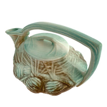 Load image into Gallery viewer, Striking vintage matted glazed Pinecone teapot in shades of green and brown. Crafted by McCoy Pottery, 1946. This rare teapot is must for any McCoy art pottery collector and a nice complement to your Christmas, cottage or lodge decor!

In good vintage condition, chip at spout, no crazing/cracks/repairs, Maker&#39;s mark on the bottom.

Measures 9 3/4 x 6 1/4 x 6 1/4 inches
