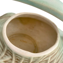 Load image into Gallery viewer, Striking vintage matted glazed Pinecone teapot in shades of green and brown. Crafted by McCoy Pottery, 1946. This rare teapot is must for any McCoy art pottery collector and a nice complement to your Christmas, cottage or lodge decor!

In good vintage condition, chip at spout, no crazing/cracks/repairs, Maker&#39;s mark on the bottom.

Measures 9 3/4 x 6 1/4 x 6 1/4 inches
