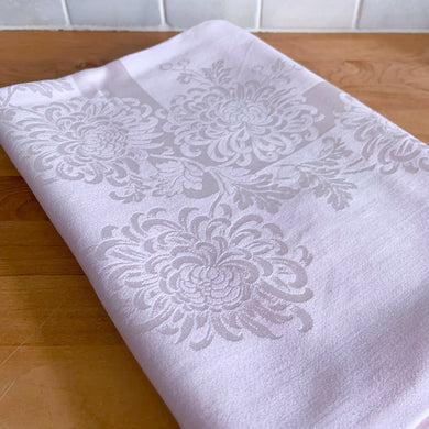 Add a touch of elegance to any table setting with this vintage pink-on-pink damask Belgian linen tablecloth, showcasing a charming pattern of Chrysanthemum flowers. Free from stains/tears. Measures 66 x 51 inches