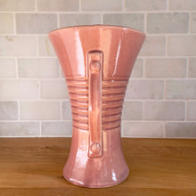 Load image into Gallery viewer, Vintage gloss pink art deco trumpet vase with ribbed design and&nbsp;strap handles. Crafted by Brush McCoy Pottery, 1940s. This rare vase must for any art pottery collector!

In excellent vintage condition, no chips/cracks/repairs. Marked on the bottom, Brush&nbsp; USA 579 8.

Measures 5 5/8 x 8 1/4 inches

