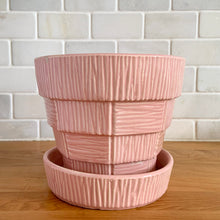 Load image into Gallery viewer, Highly collectible vintage mid-century pink basketweave ceramic planter with attached underplate. Crafted by McCoy Pottery, 1950s. The perfect home for your favourite houseplant or succulent and a must-have for any art pottery collector!

In excellent vintage condition, no chips/cracks/repairs, age-related crazing. Maker&#39;s mark.

Measures 6 1/2 x 5 5/8 inches
