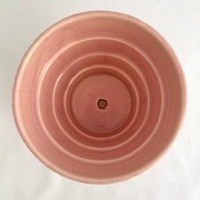 Load image into Gallery viewer, Sweet vintage mid-century pink ceramic planter featuring a basketweave pattern and attached underplate or saucer. Crafted by McCoy Pottery, USA circa 1950s. Highly collectible and absolutely gorgeous, this planter would look great with your favourite houseplant or succulent!  In excellent condition, free from chips/cracks/repairs.  Measures 4 1/4 x 3 7/8 inches
