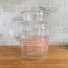 Load image into Gallery viewer, Fantastic vintage mid-century beverage pitcher decorated with a pink basketweave pattern topped with a band of white ivy and ribbed handle. Produced by Federal Glass, circa 1950s. The perfect addition to any style vintage kitchen and your tablescape will thank you! Glassware dreams are made of this beauty!  In like new condition, free from chips/wear. The paint is vibrant and shiny. Unmarked.  Measures 5 x 8 inches  Capacity 90 ounces
